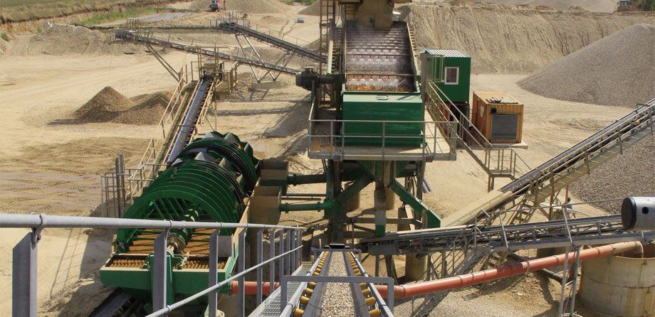 Photo: Conveyor belt system running in different directions in the midst of a large gravel storage site